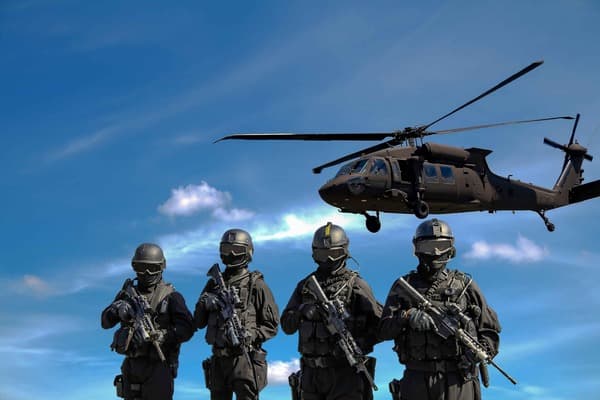 Military personnel and a helicopter