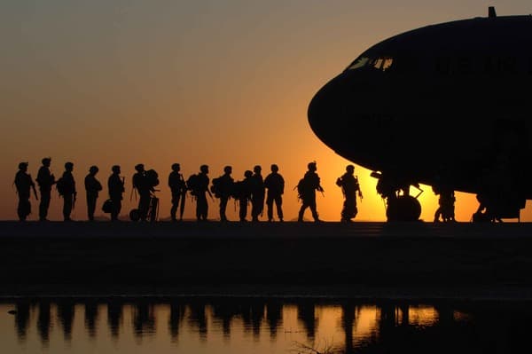 Military personnel and a plane