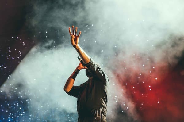 Musician performing live on stage, highlighting the risk of tinnitus in the music industry.