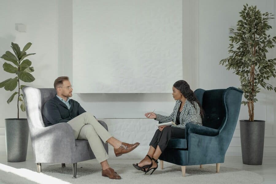 Therapist and patient in discussion, representing understanding the psychological impact of tinnitus and mental health.